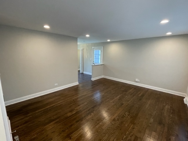 15303 Birch Road Markham, IL 60428 - Photo 7 of 12 an empty room with wooden floor and windows