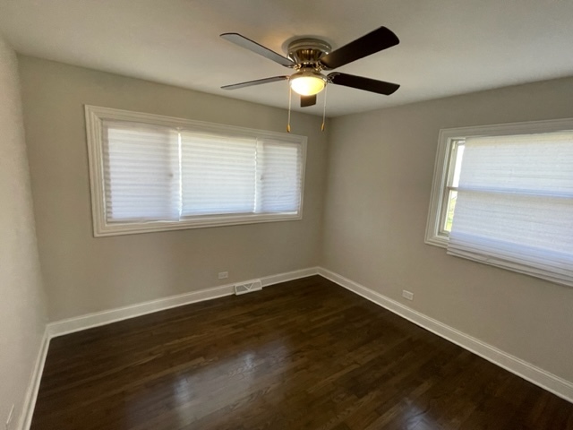15303 Birch Road Markham, IL 60428 - Photo 8 of 12 a view of a room with wooden floor and windows