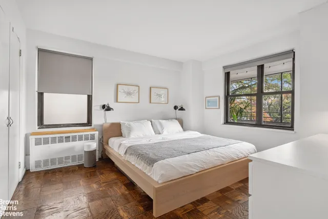 a spacious bedroom with a bed and a window