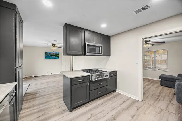 a kitchen with stainless steel appliances granite countertop a stove and a refrigerator