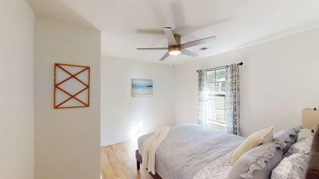 a bedroom with a large bed and a window