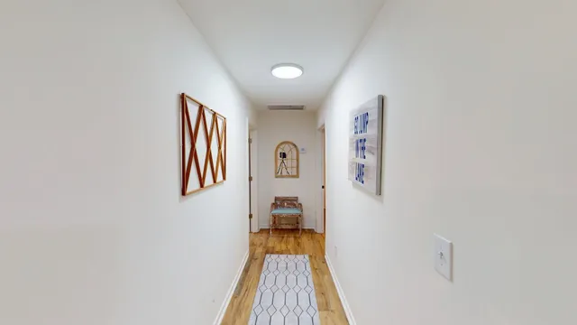 a view of a hallway with a bedroom