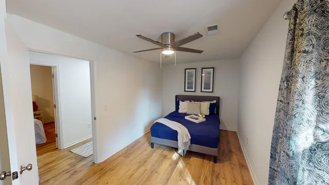 a bedroom with a bed and a chandelier