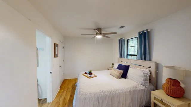 a bedroom with a bed and window