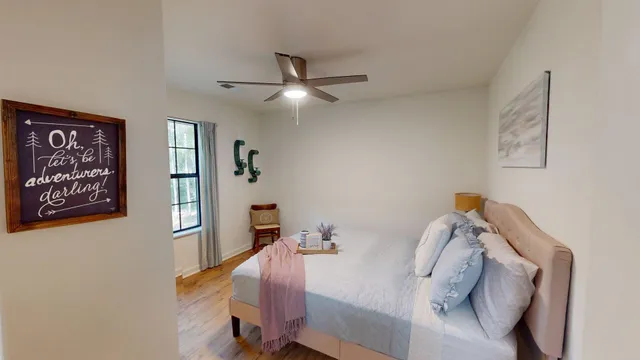 a bedroom with a bed and a chandelier