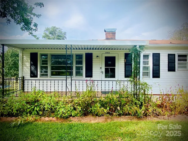 front view of a brick house with a large window