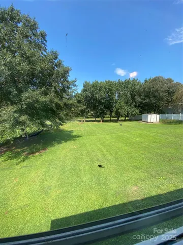 a front view of a house with a yard and a garage