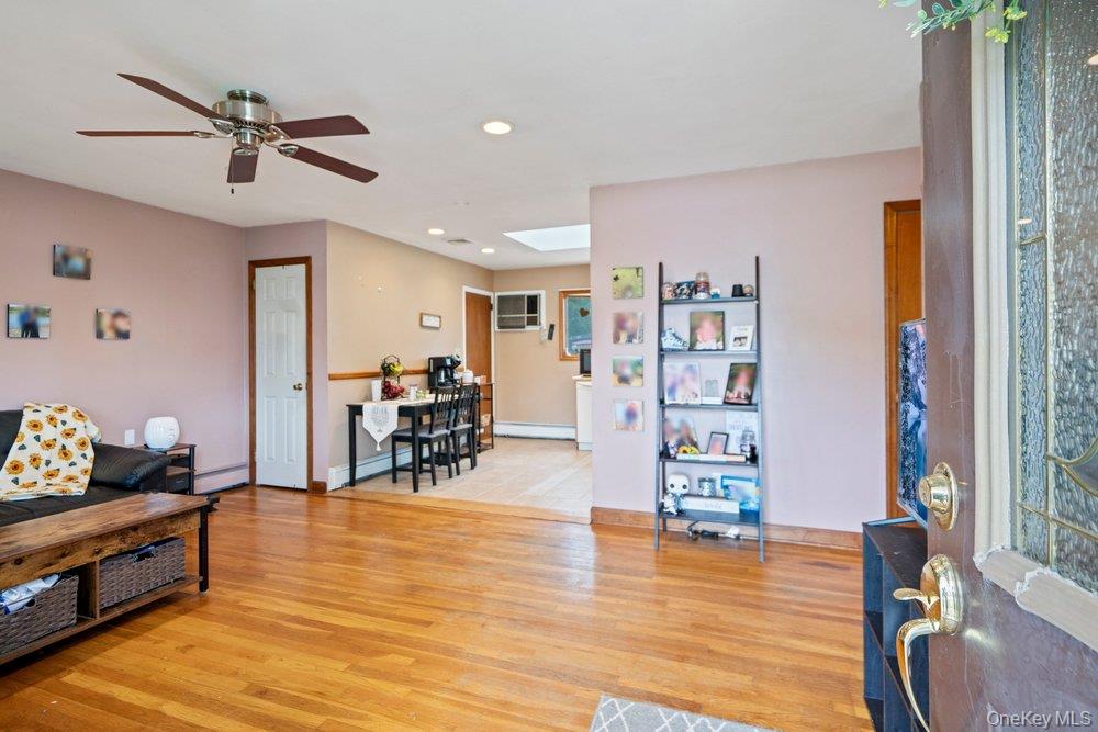 101 Sexton Road West Babylon, NY 11704 - Photo 9 of 33 a living room with furniture and wooden floor