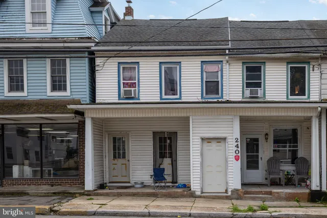 a view of a livingroom with workspace and a window