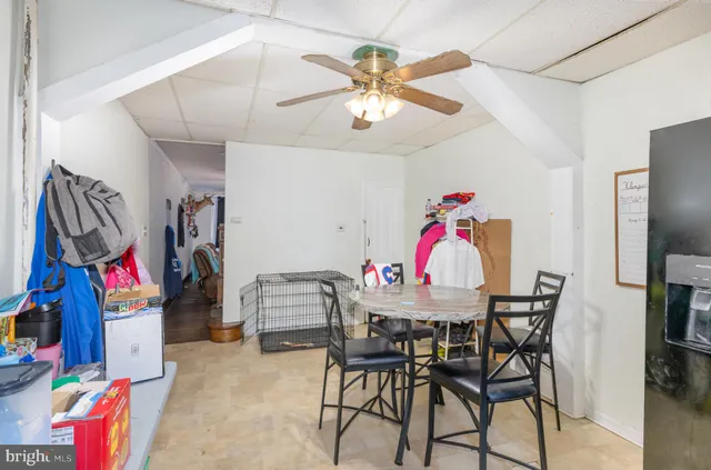 a kitchen that has a lot of cabinets and wooden floor