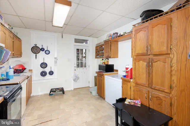 a kitchen with stainless steel appliances granite countertop a sink dishwasher and cabinets with wooden floor