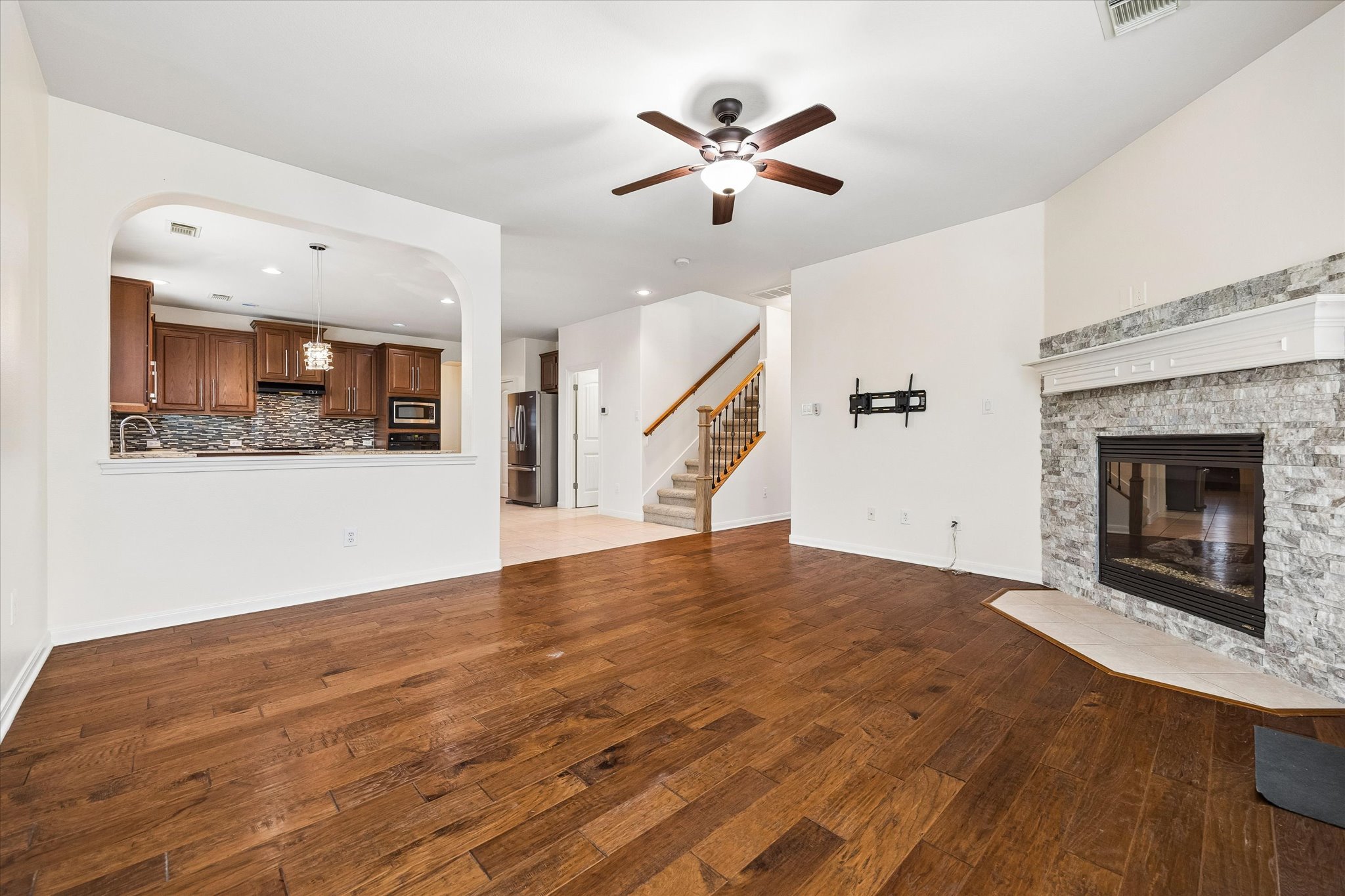 206 Saddle Ridge Drive Cedar Park, TX 78613 - Photo 6 of 20 a view of an empty room with wooden floor and a fireplace