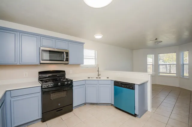 a kitchen with a sink stove and microwave