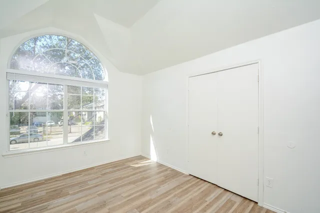 a view of a room with wooden floor and white walls