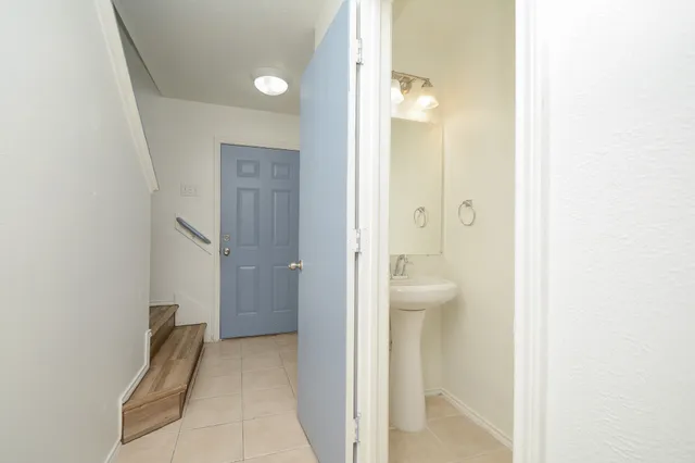 a view of a bathroom from a hallway with toilet