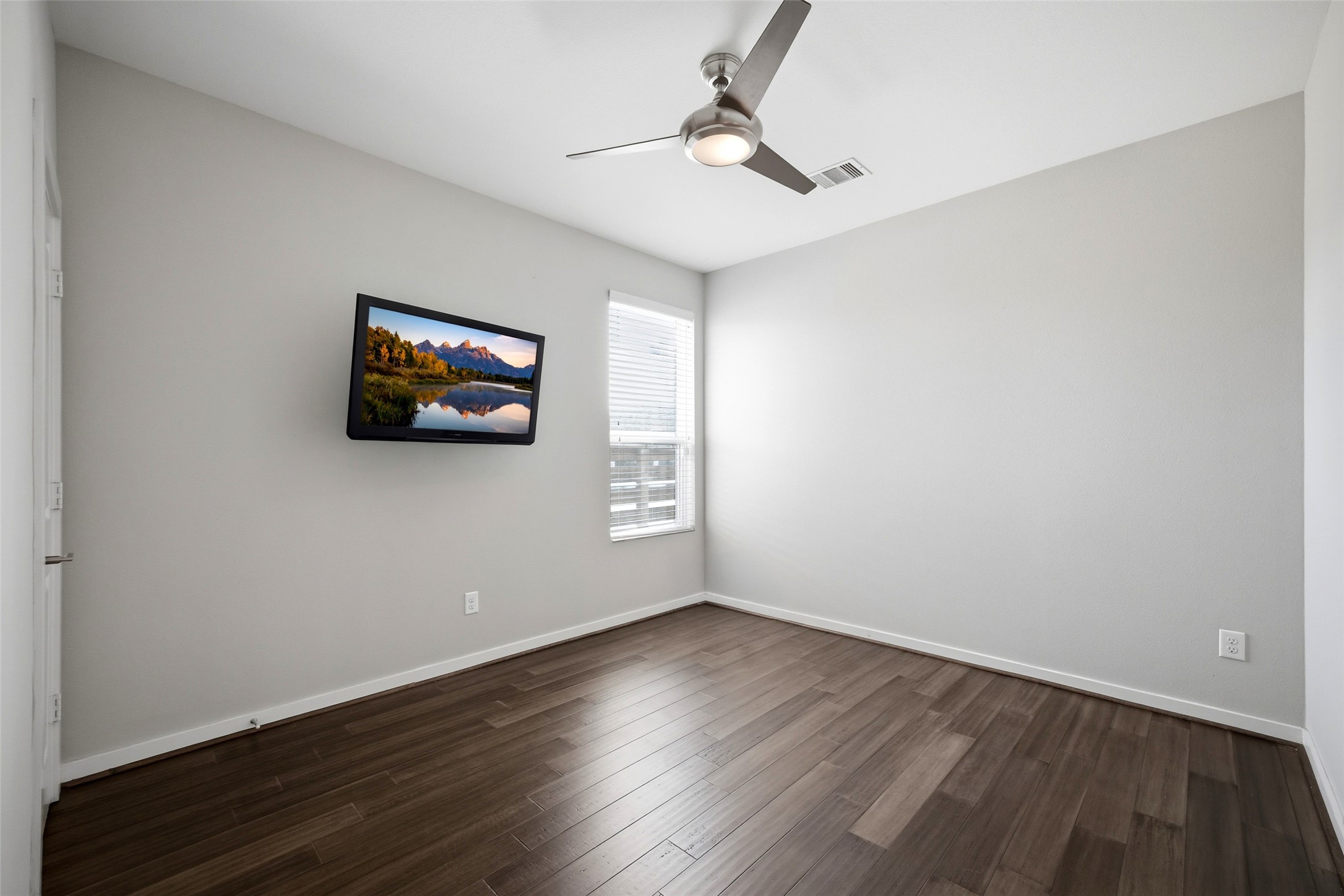 605 Dumble Street Houston, TX 77023 - Photo 35 of 44 a view of empty room with wooden floor and fan
