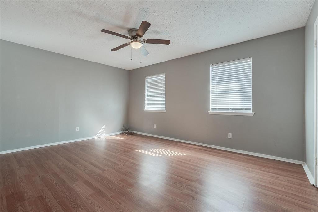 3959 North Garland Avenue, Unit 1 Garland, TX 75040 - Photo 11 of 11 a view of an empty room with wooden floor and a window