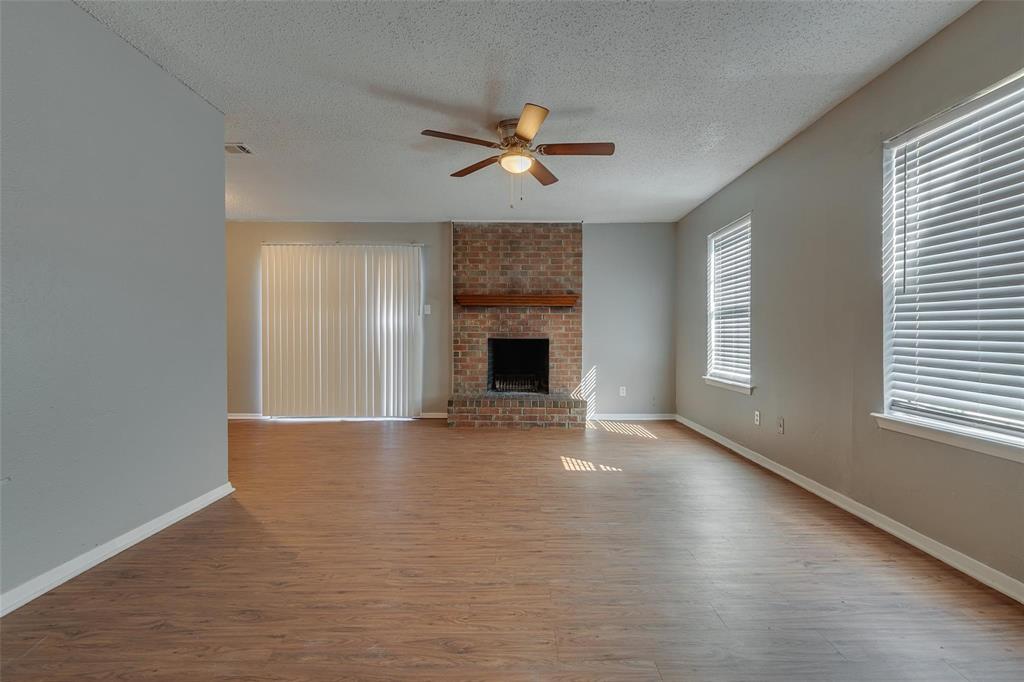3959 North Garland Avenue, Unit 1 Garland, TX 75040 - Photo 8 of 11 an empty room with windows and fireplace