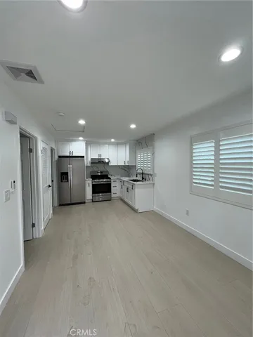 a view of kitchen and kitchen island refrigerator sink