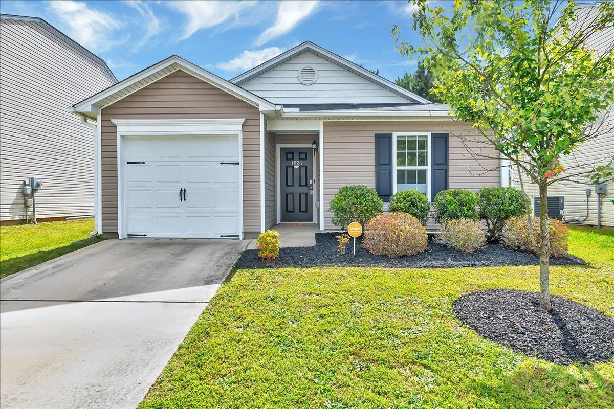 a view of a house with a swimming pool and a yard