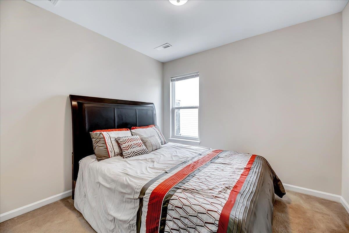 1621 Brownairs Lane Raleigh, NC 27610 - Photo 13 of 29 a bedroom with a bed and a window