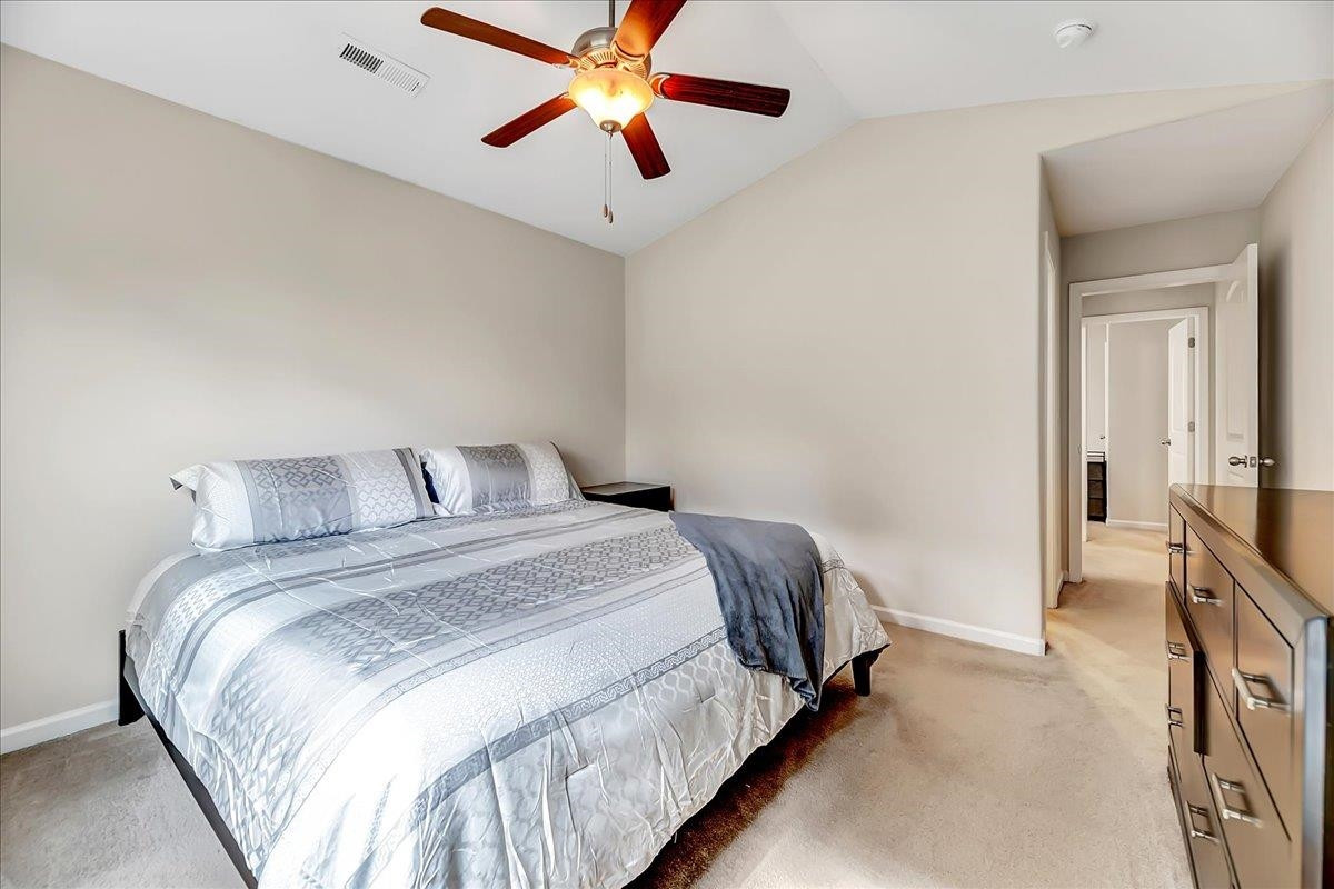 1621 Brownairs Lane Raleigh, NC 27610 - Photo 16 of 29 a bedroom with a bed and a chandelier