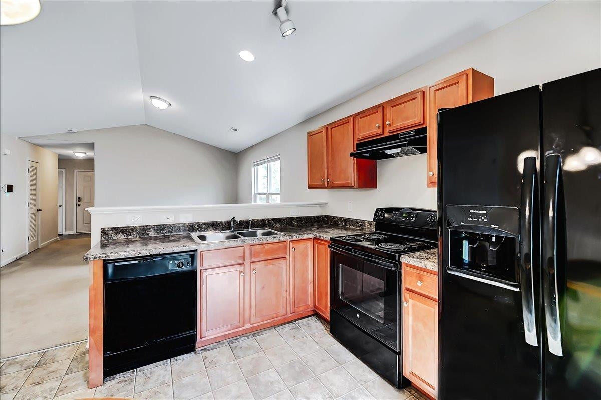 1621 Brownairs Lane Raleigh, NC 27610 - Photo 20 of 29 a kitchen with stainless steel appliances granite countertop a stove top oven a sink and a refrigerator