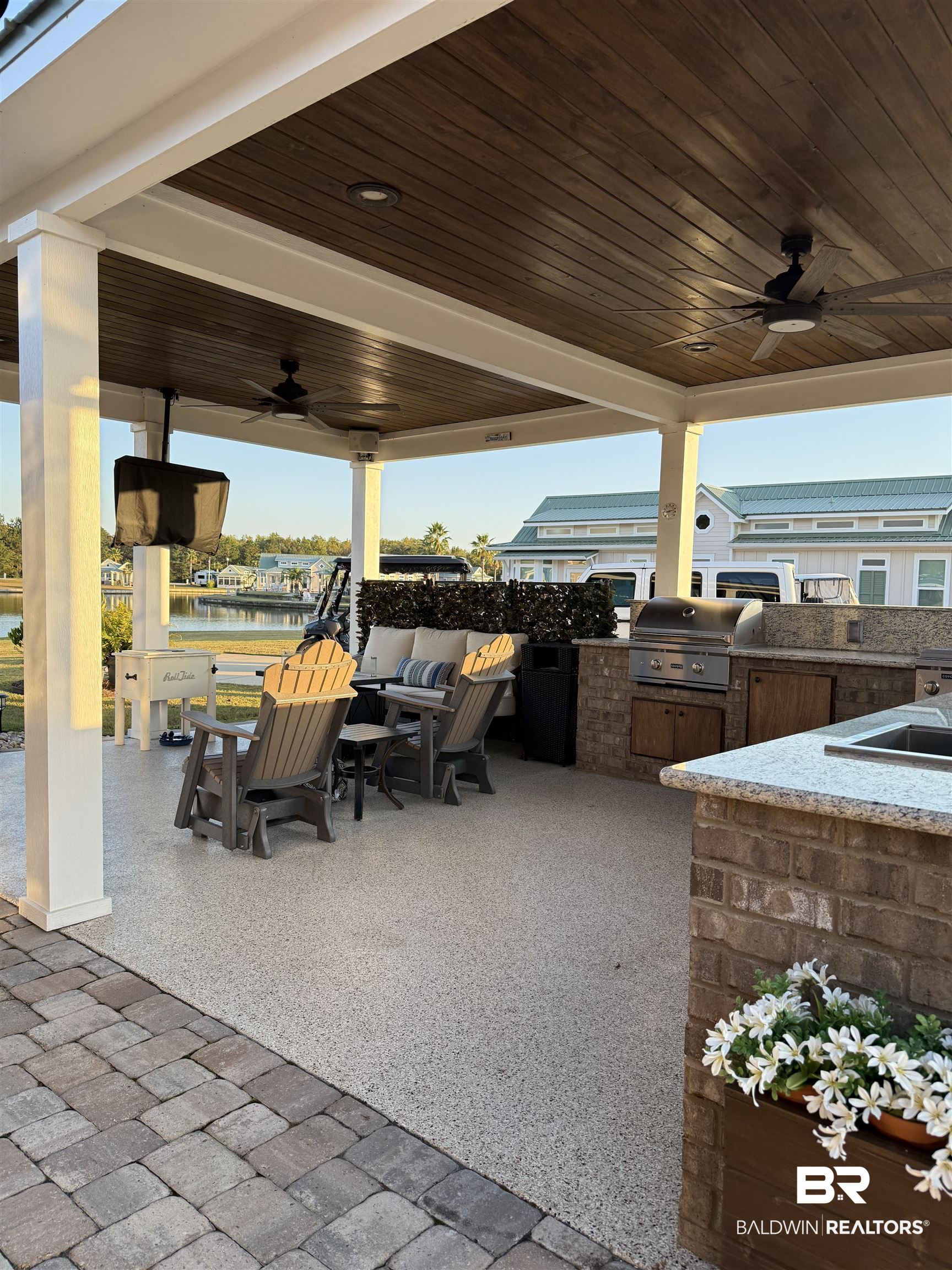 28238 Migratory Way Elberta, AL 36530 - Photo 11 of 58 View of patio featuring area for grilling, a ceiling fan, and a water view