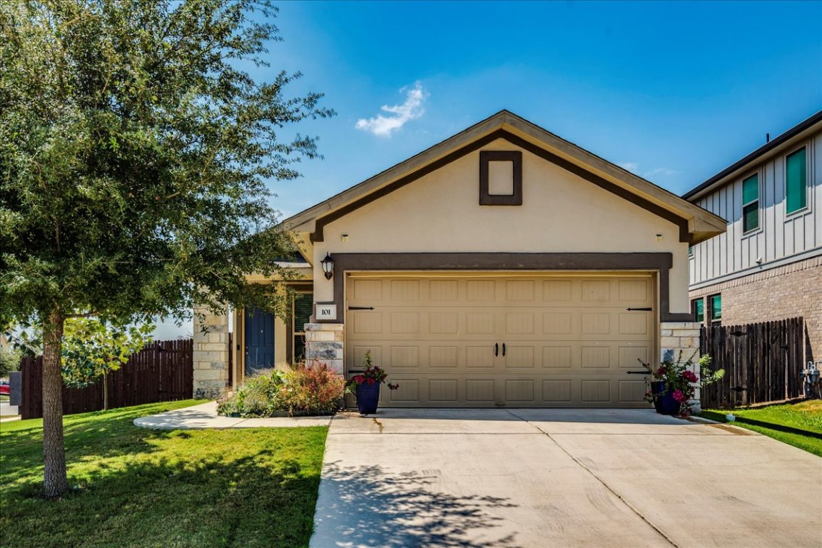 101 Otella Street Georgetown, TX 78628 - Photo 1 of 33 a front view of a house with a yard and garage