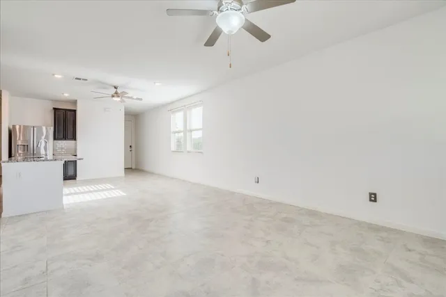 a view of a livingroom with a ceiling fan and window