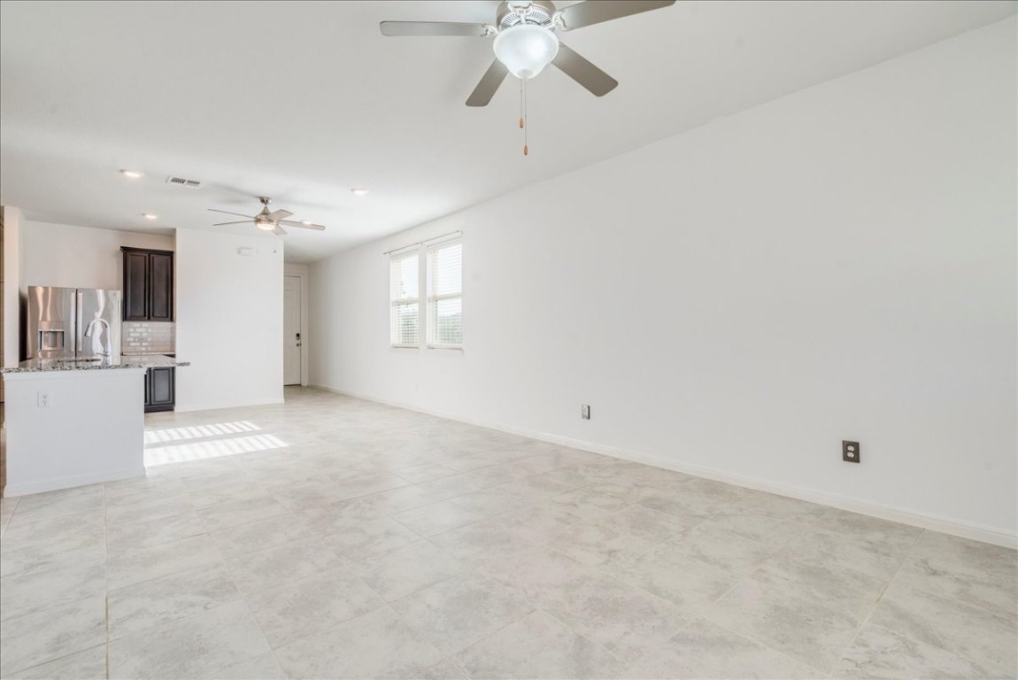 101 Otella Street Georgetown, TX 78628 - Photo 12 of 33 a view of a livingroom with a ceiling fan and window