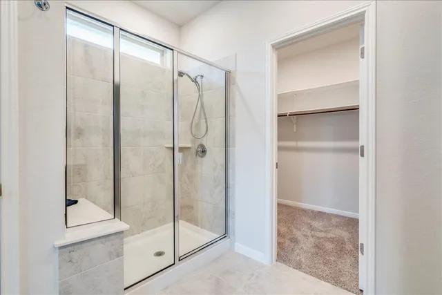 a bathroom with a glass shower door