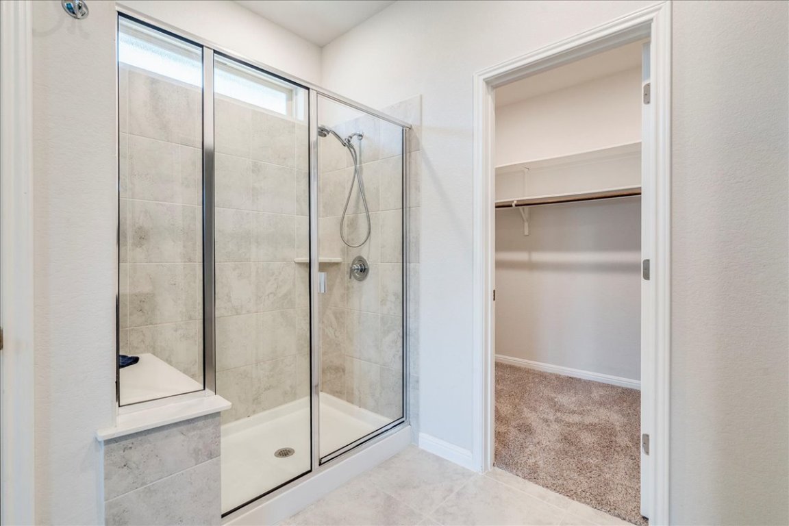 101 Otella Street Georgetown, TX 78628 - Photo 17 of 33 a bathroom with a glass shower door