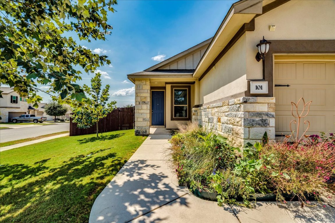 101 Otella Street Georgetown, TX 78628 - Photo 2 of 33 a front view of a house with garden