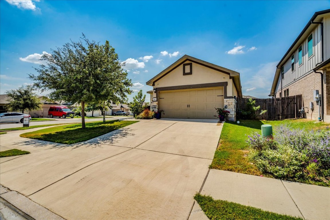 101 Otella Street Georgetown, TX 78628 - Photo 32 of 33 a front view of a house with a yard and garage