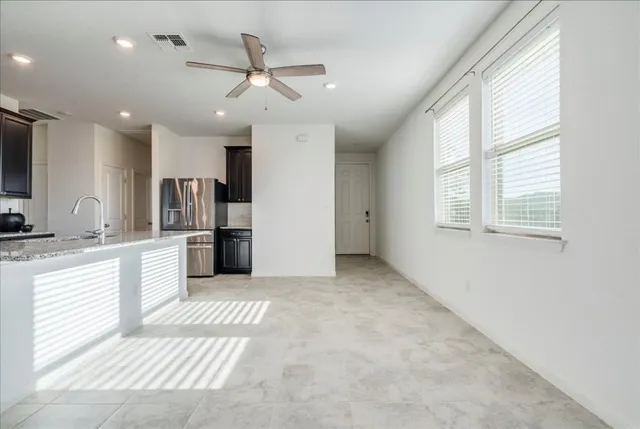 a view of a kitchen with a sink and stainless steel appliances