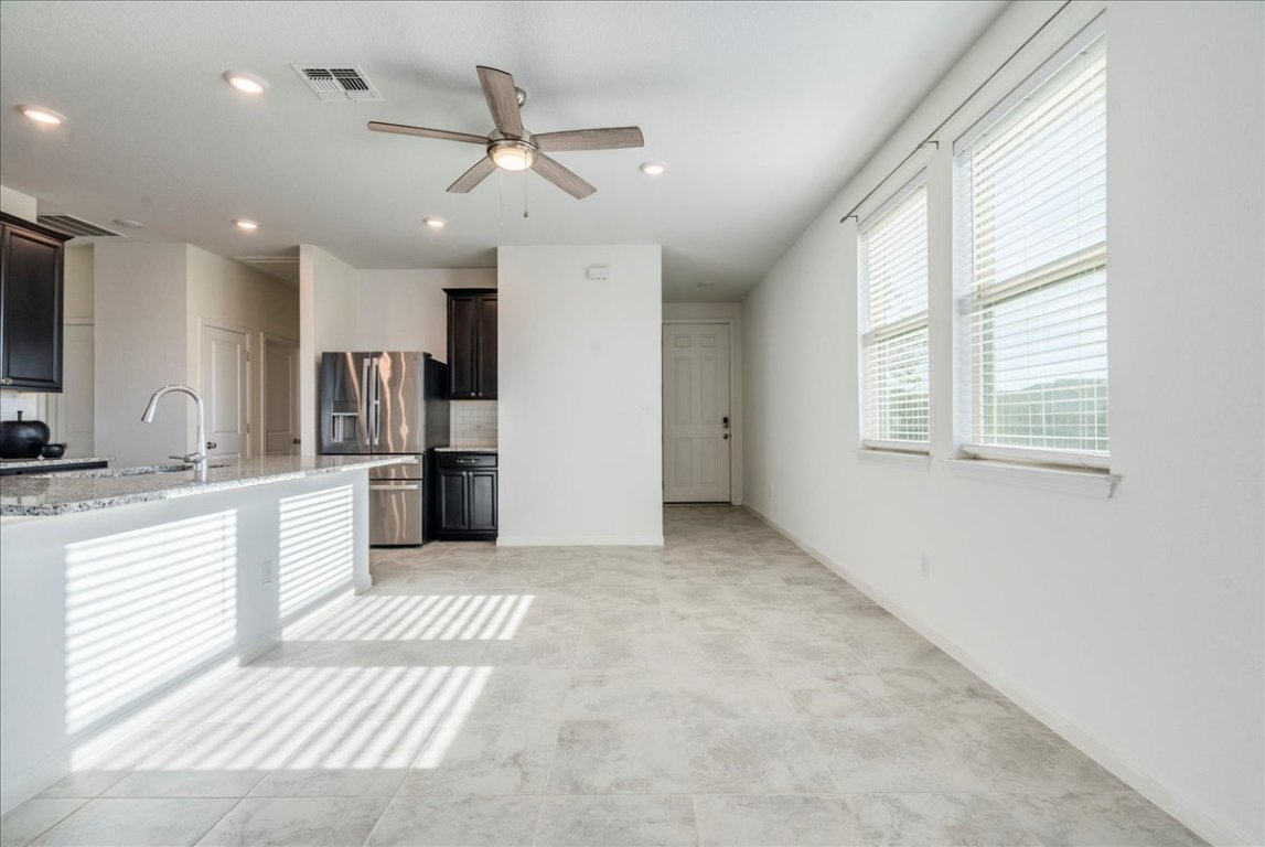 101 Otella Street Georgetown, TX 78628 - Photo 9 of 33 a view of a kitchen with a sink and stainless steel appliances