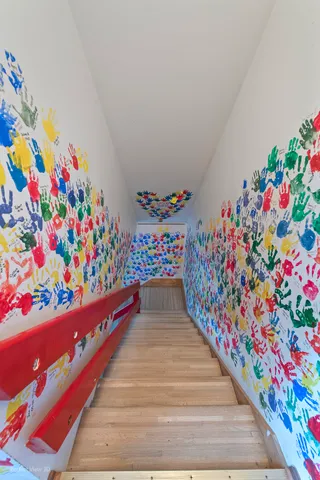 a view of a hallway with stairs and a couch