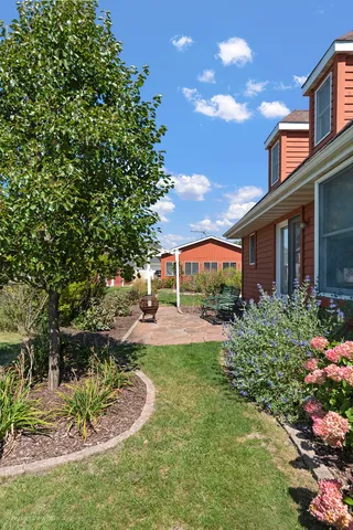 a view of a house with a yard and fountain