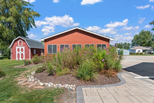 a view of a house with a yard and a garden
