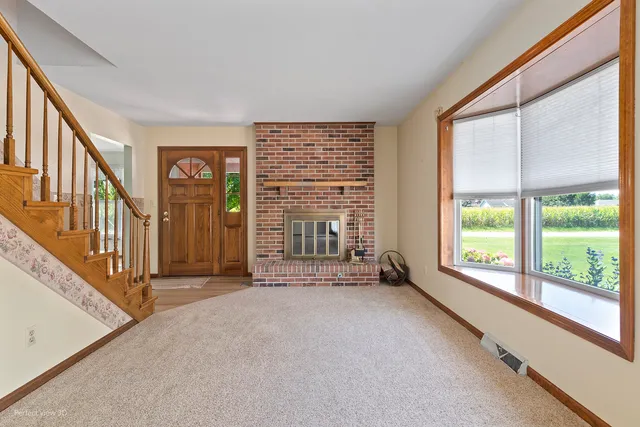 a view of a livingroom with a ceiling fan and window