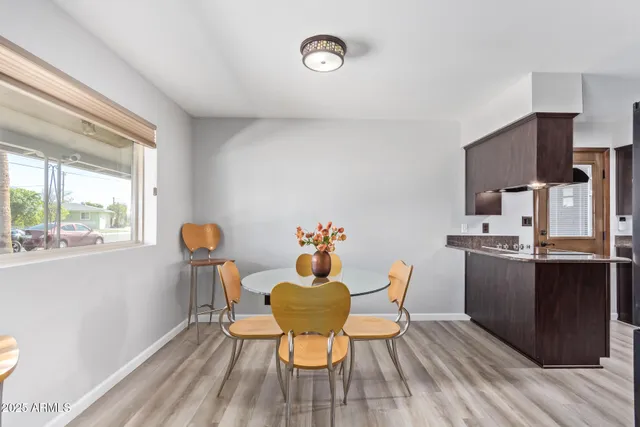 a dining room with furniture and a window