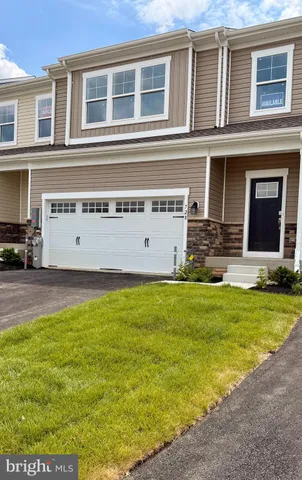 a large building with potted plants in front of it