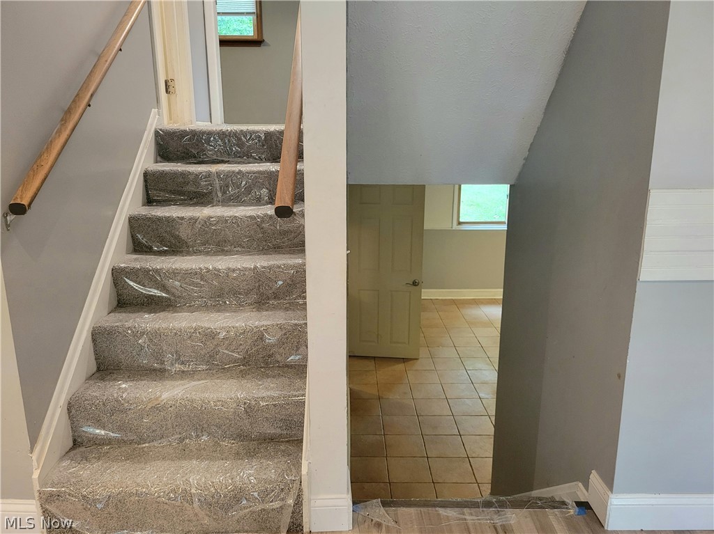 4895 Lear Nagle Road North Ridgeville, OH 44039 - Photo 13 of 27 Stairs with tile floors and plenty of natural light