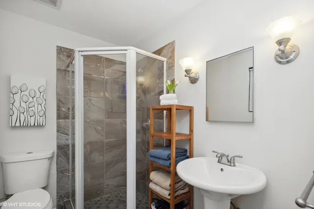 a bathroom with a sink toilet and shower
