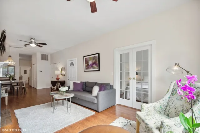 a living room with furniture and wooden floor