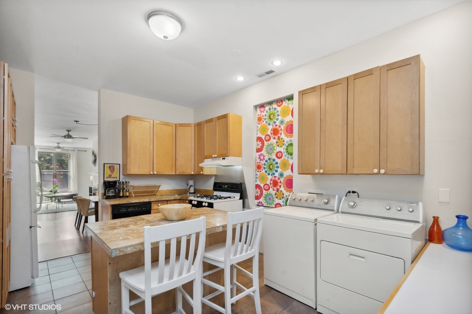 2008 West Roscoe Street, Unit 2 Chicago, IL 60618 - Photo 6 of 13 a white kitchen with stainless steel appliances granite countertop a stove a sink and a refrigerator