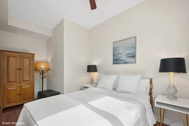 a bedroom with a bed and a lamp