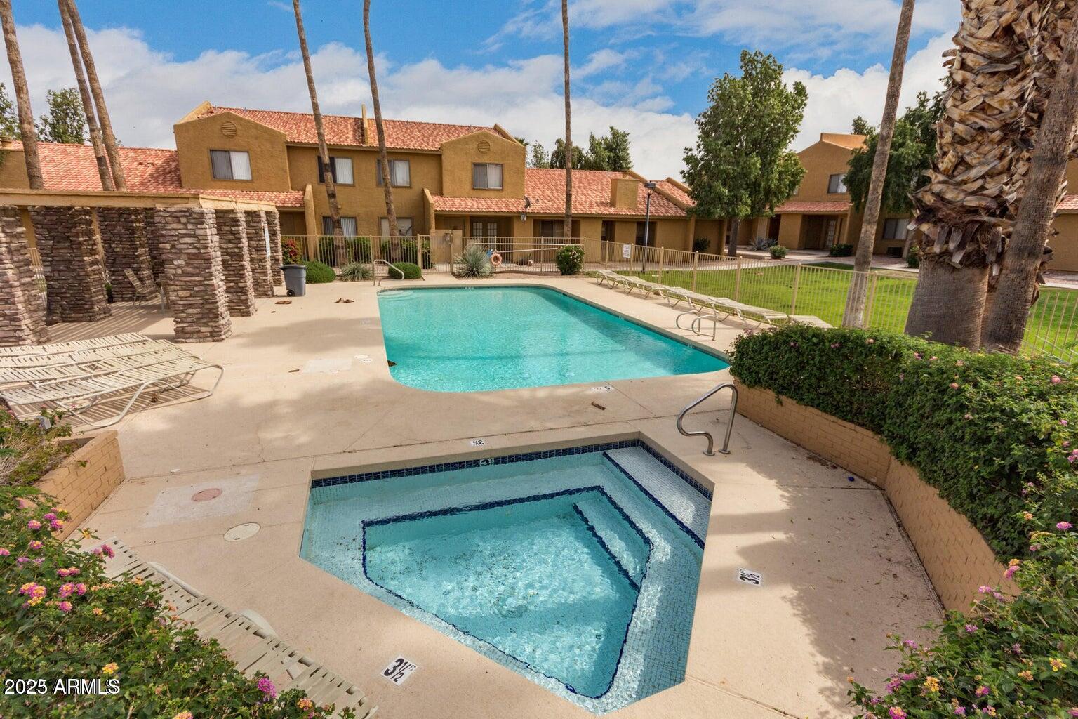 3511 East Baseline Road, Unit 1216 Phoenix, AZ 85042 - Photo 5 of 11 a view of a swimming pool with a yard