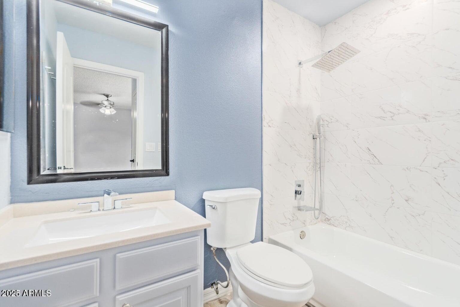 3511 East Baseline Road, Unit 1216 Phoenix, AZ 85042 - Photo 8 of 11 a bathroom with a sink a toilet and shower